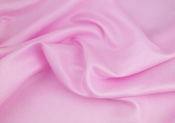 Pink satin or silk fabric background.	