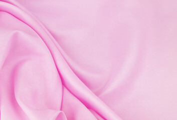 Pink satin or silk fabric background.	