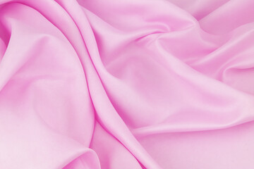 Pink satin or silk fabric background.	