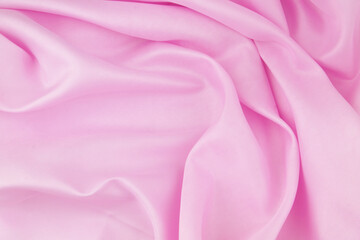 Pink satin or silk fabric background.