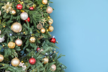 Beautiful decorated Christmas tree on blue background, closeup