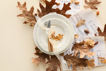 Autumn table setting and music notes on beige background