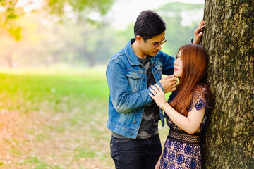 Fototapeta premium Portrait asia young couple in love, boyfriend and girlfriend happy in park