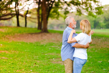 Naklejka na ściany i meble Portrait caucasian senior woman and old man, couple elder in love happy in park