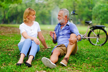 senior woman take care old man That is tired from exercise in park