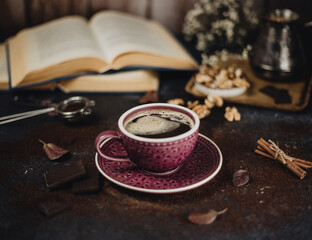 coffee in a purple mug and books 