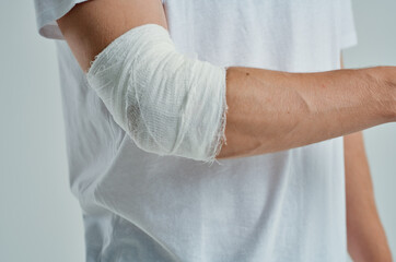 sick man in a white T-shirt with a bandaged hand hospital medicine