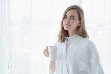 girl drinking hot coffee or tea in morning