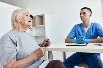elderly woman at the doctor's and nurse's appointments professional advice