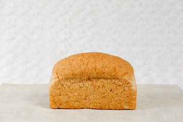 Wheat bread loaf on a white background.