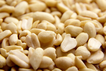 Raw blanched peanuts as food background