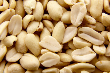 Raw blanched peanuts as food background
