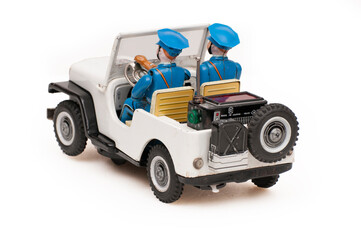 vintage tin police car toy on white background
