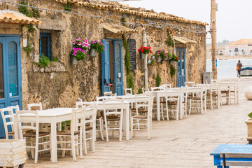 picturesque village of Marzamemi, in the province of Syracuse, Sicily - Tables and chairs setup in...