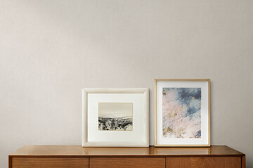 Picture frames on a wooden cabinet