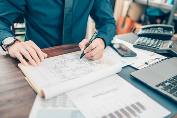A man hand planning daily appointment and note at office desk. Planner plan Schedule Calendar and reminder. Business planning appointment concept. © Charnchai saeheng