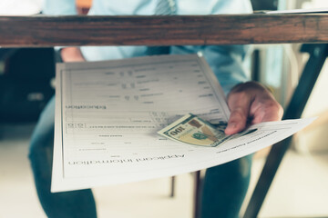 Naklejka premium Men attach money to job applications. A man bribe for a new job..job vacancy, job application concept.