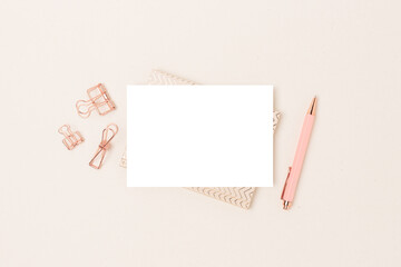 Paper card mockup and stationery on a beige background. Minimalistic business workspace.