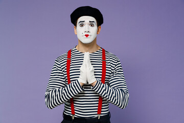 Charming young mime man with white face mask wears striped shirt beret gloves hands folded in...