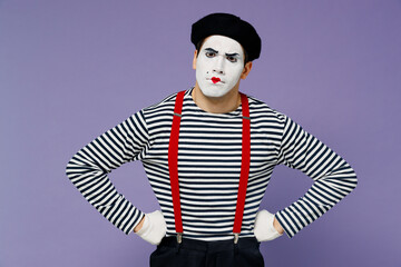 Strict nervous displeased irritated young mime man with white face mask wears striped shirt beret...