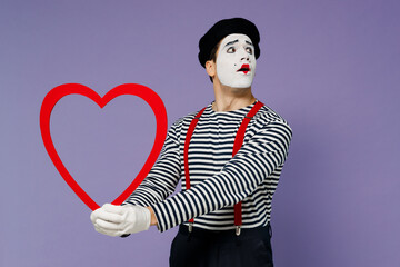 Charismatic thoughtful romantic young mime man with white face mask wears striped shirt beret...