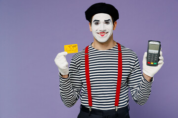 Young mime man with white face mask wear striped shirt beret hold wireless modern bank payment...