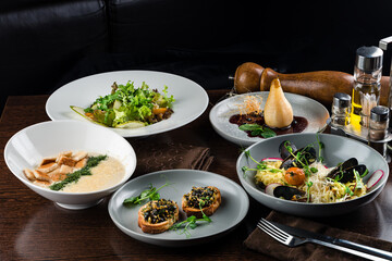 Italian risotto with roasted chicken, snacks on dark wooden table. Italian food table, top view