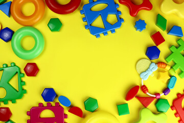 Fototapeta na wymiar Frame of children's educational toys on a yellow background