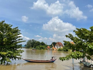 A river with boats passing through different places.