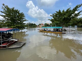 A river with boats passing through different places.