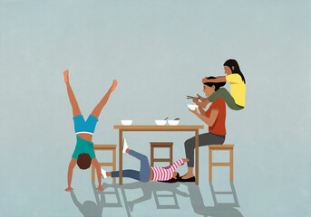 Playful kids distracting mother eating at table
