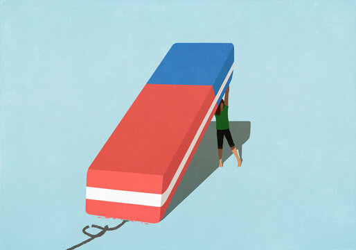 Woman lifting large eraser
