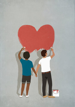 Couple holding hands painting heart on wall

