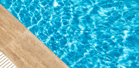 Border of swimming pool and blue ripped turquoise water. Summer vacation concept. Banner with copy space