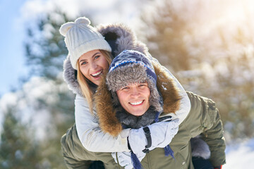 Couple having fun in winter scenery and snow