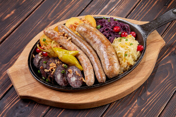 Traditional german fried meat with boiled potatoes, red cabbage and vegetables