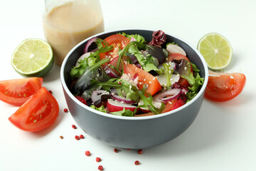 Concept of tasty food with vegetable salad with tahini sauce on white background