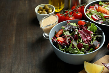 Concept of tasty food with vegetable salad with tahini sauce on wooden background