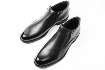 New black shoes for men with zippers isolated on a white background. Men's comfortable shoes. Top view, flat lay.