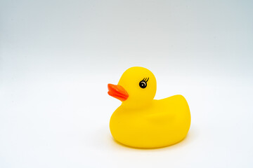 Yellow duck with red beak baby bath toy isolated on white background