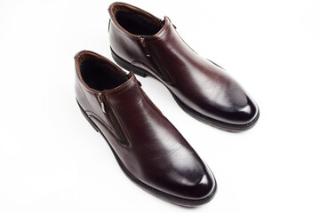 New brown men's shoes isolated on white background. A pair of men's shoes. Top view, flat lay.