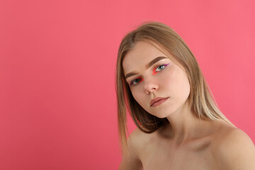 Beautiful model girl with makeup on pink background