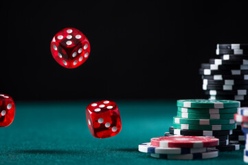  Casino Chips Stack and Flying Dices on Green Poker Table