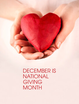 December is National Giving Month stock images. Female hands giving red heart stock photo. Red heart in female hands stock images