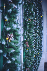 Christmas decoration with pine twigs and garlands store facade.