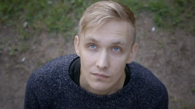 Video of blond man looking up and appealing to God