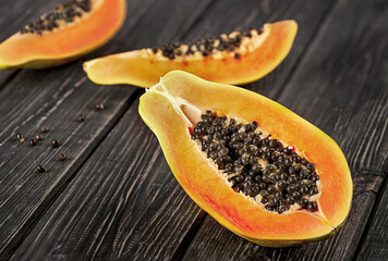 Several pieces of ripe papaya on a wooden table