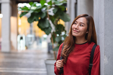 A young asian woman walking on the street while traveling and sightseeing around the city