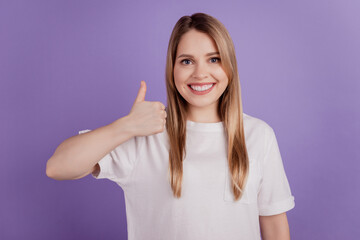 Photo of cheerful reliable lady raise thumb up agree solution wear casual clothes on violet background