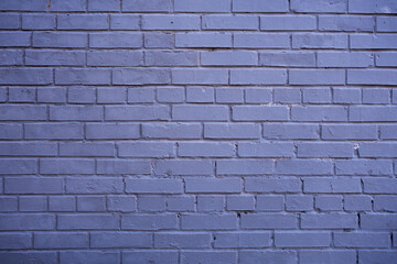 Lavender coloured brick wall texture background. Painted in purple empty wall. Horizontal photo.